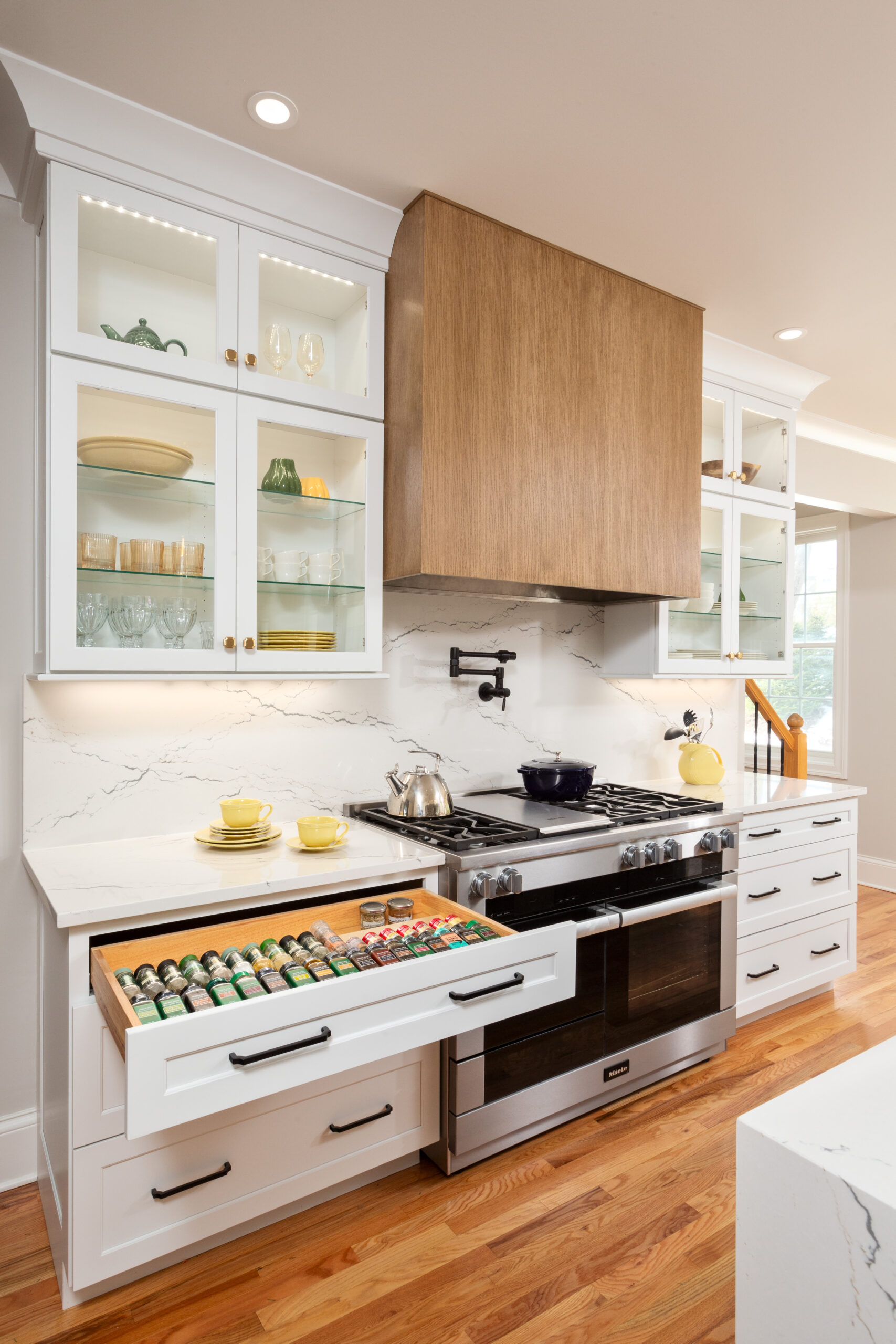 Custom kitchen spice drawer with built-in organizer inside white shaker cabinetry in modern Niskayuna kitchen remodel.